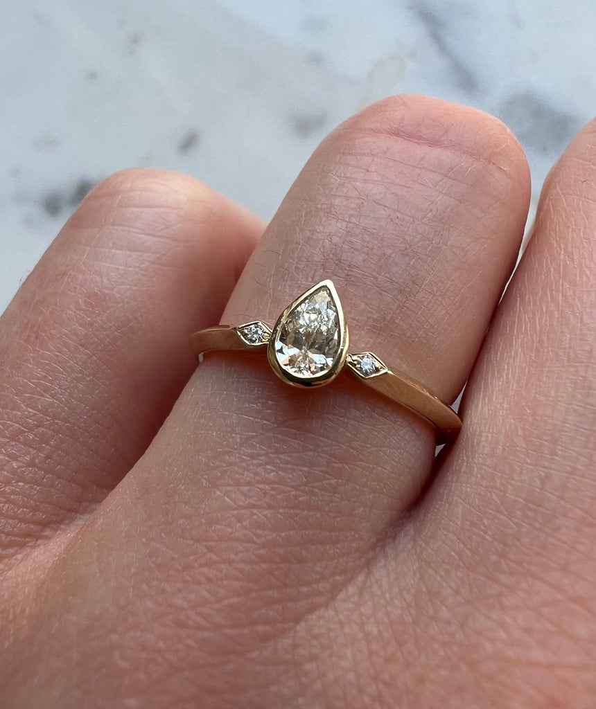 Pear shaped diamond ring being worn